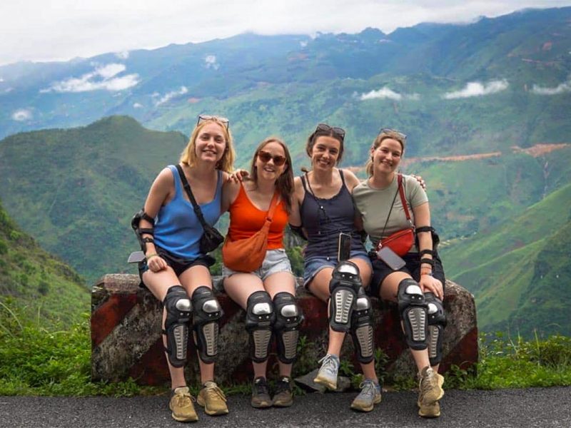 Ha Giang Loop group tour by Easy Rider motorbike with Local Vietnam, showing guests taking a break at a mountain viewpoint during a guided motorbike route