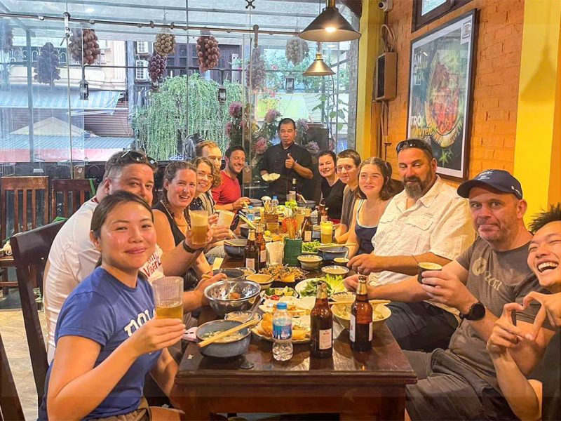 Travelers enjoying their freshly made Vietnamese food and drinks during a Hanoi cooking class