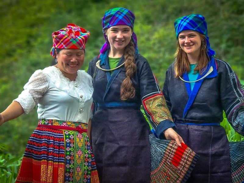 hello mu cang chai homestay 1 Two foreign girls standing dressed with ethnic costume together with a local ethnic minority woman