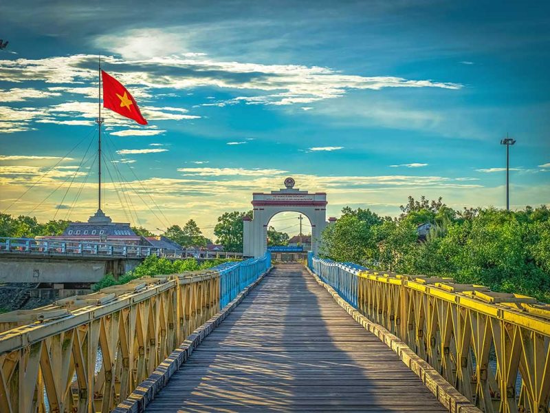 The Hien Luong Bridge with on the background the flag tower with huge Vietnamese flag in the DMZ