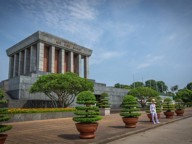 Ho Chi Minh Mausoleum with a guard in white uniform guarding it