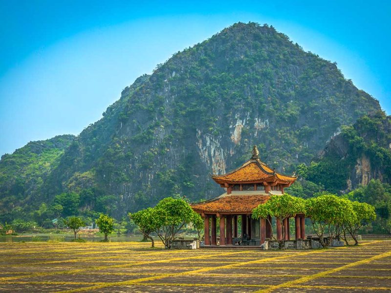 hoa lu ancient capital 4 A single limestone mountain rising above the fields at Hoa Lu Ancient Capital, with a small temple pavilion at its base, Ninh Binh