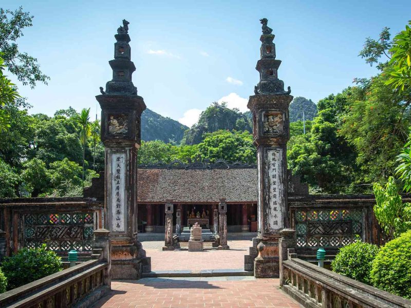 hoa lu ancient capital ninh binh The tall stone gate pillars at the entrance to Hoa Lu Ancient Capital, with karst mountains behind, Ninh Binh
