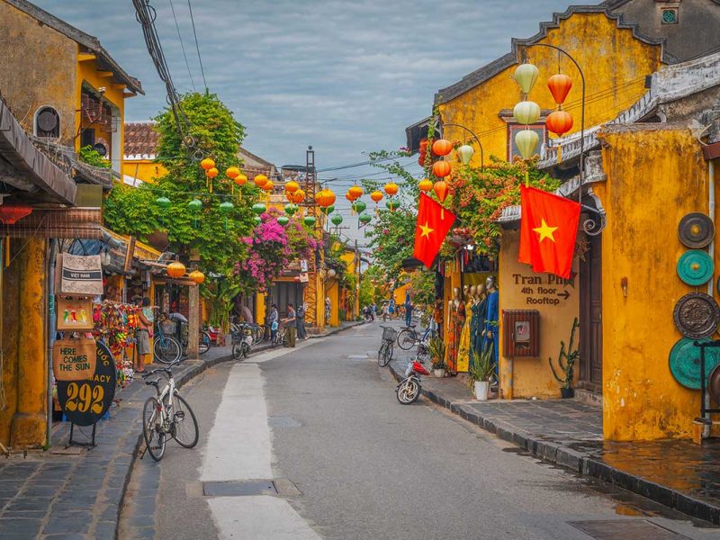 Yellow heritage houses and lanterns along the streets of Hoi An Ancient Town – a must-do walking experience in Vietnam.