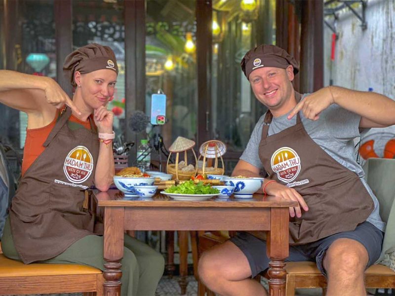 Two tourists in aprons doing a Hue cooking class