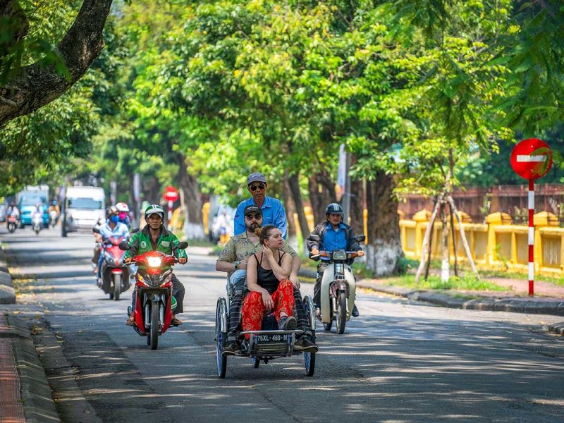hue cyclo tour 1 A couple sitting together on a cyclo while riding through Hue