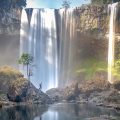 K50 Waterfall tours featuring the towering jungle waterfall and rocky pool in Kon Chu Rang