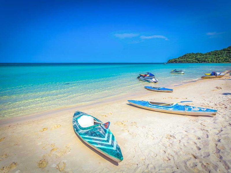 Kayaks laying on a stunning white sandy beach in Phu Quoc