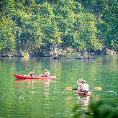 A tourist kayaking on Ba Be Lake