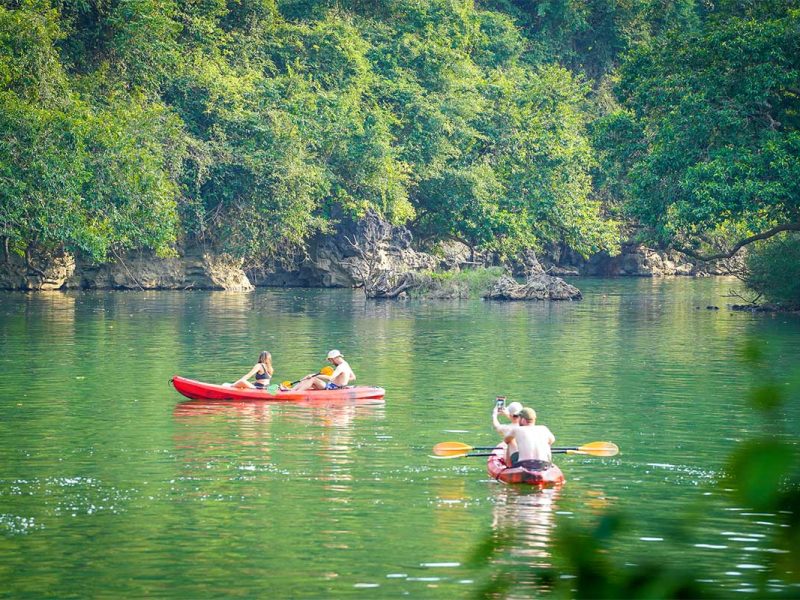 A tourist kayaking on Ba Be Lake