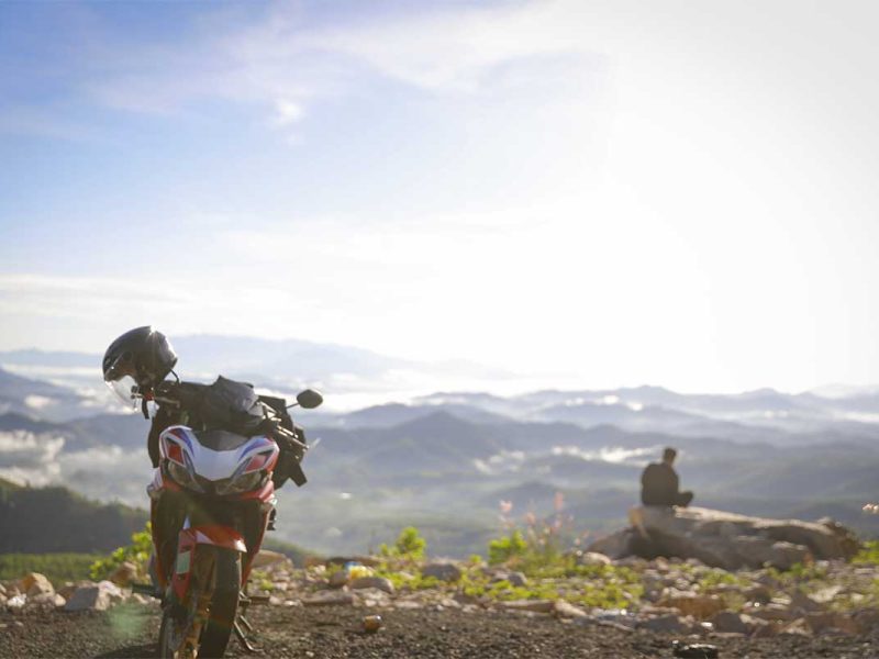 Motorbike riding along Khanh Le Pass, capturing the adventurous way to travel between Dalat and Nha Trang through mountain scenery