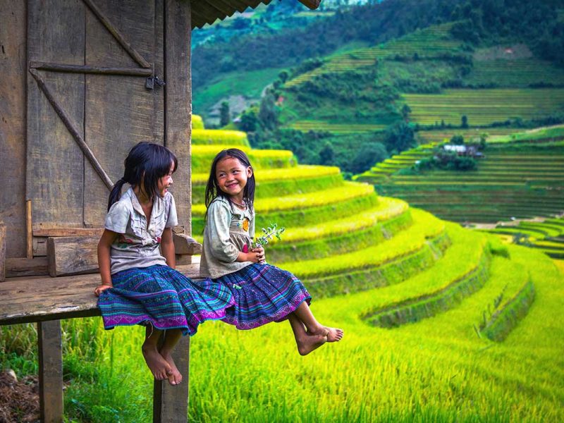 kids in Sapa sitting at a house overlooking stunning terraced rice fields