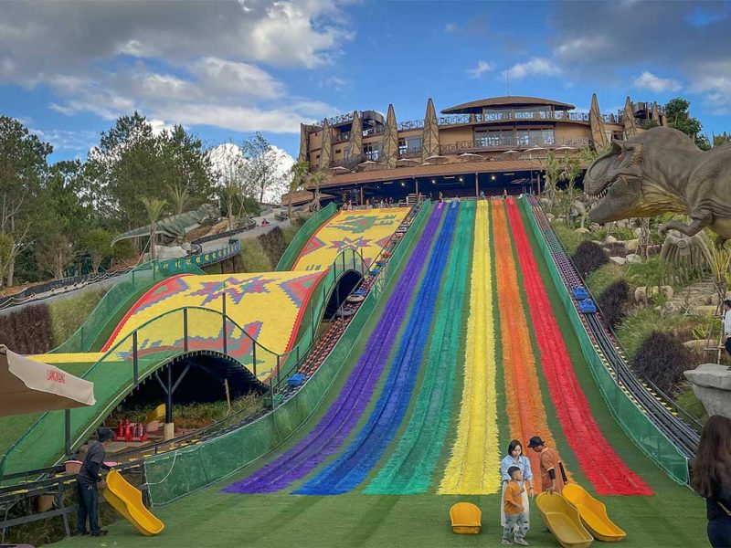 Colorful hillside slide attraction at Langbiang Land, a family-friendly stop near Langbiang Mountain in Dalat