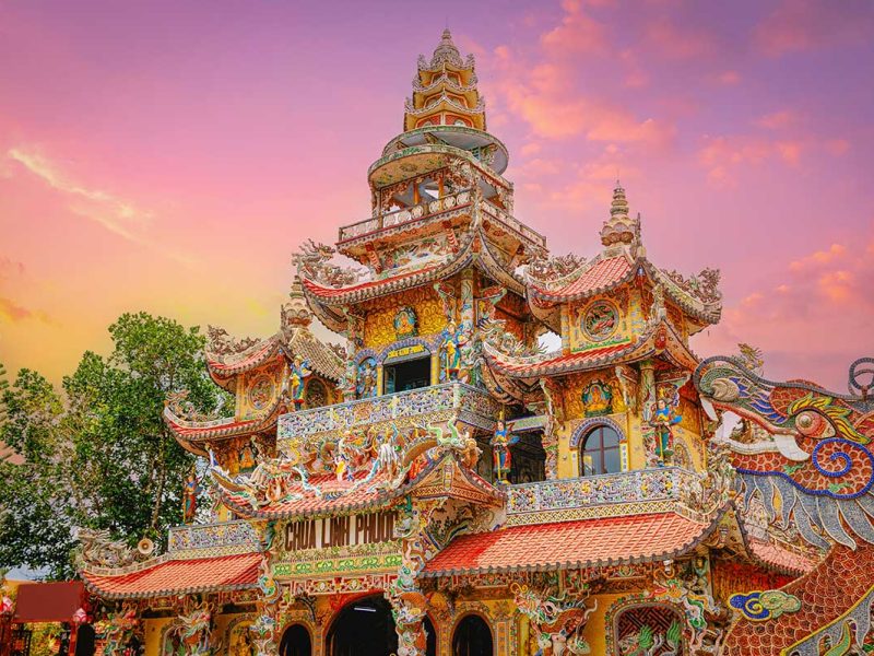Exterior of Linh Phuoc Pagoda in Dalat, a famous mosaic temple known for its detailed dragon designs and vibrant colors