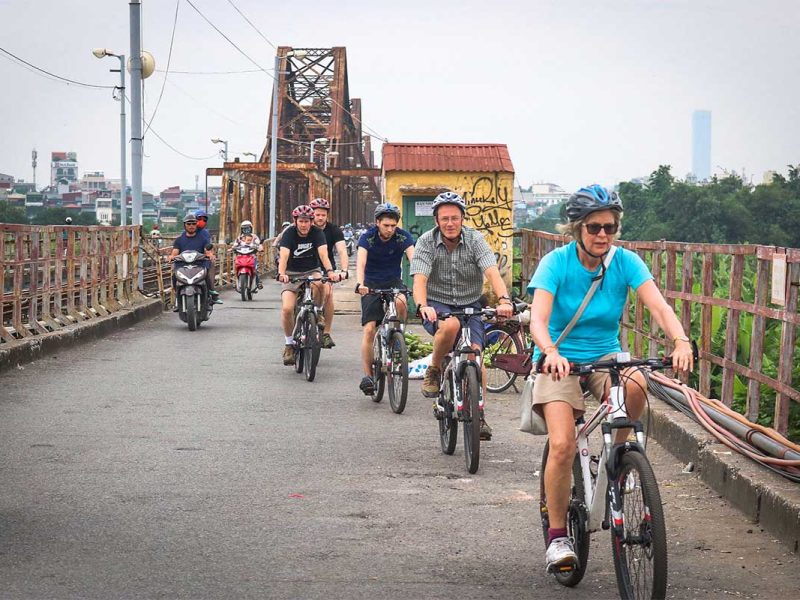 long bien bridge cycling tour hanoi 4 Cycling tour group riding across Long Bien Bridge during a Hanoi bike tour