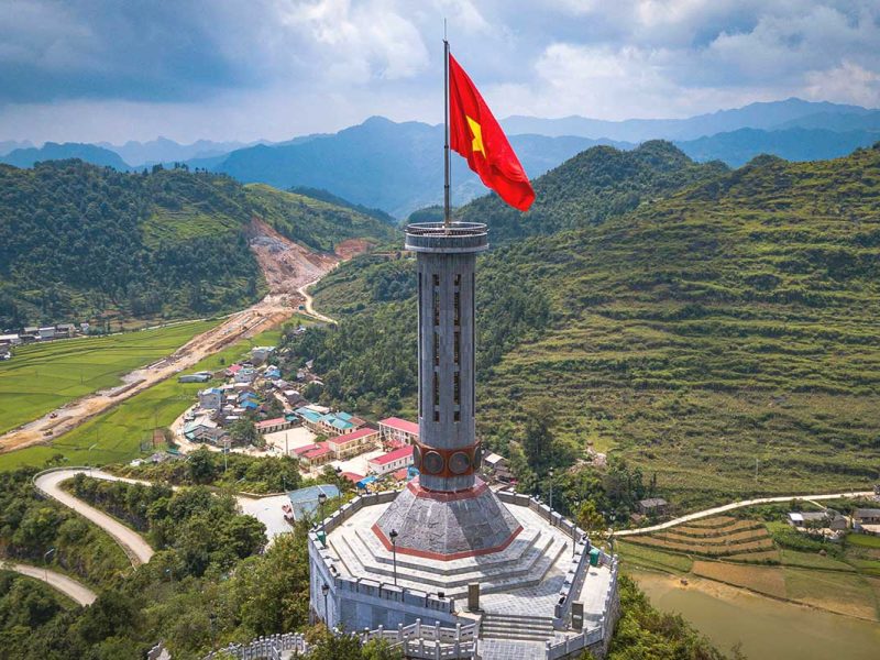 Close-up aerial view of Lung Cu Flag Tower – The Lung Cu Flag Tower, standing tall on Rong Mountain, symbolizing Vietnam’s northernmost point.