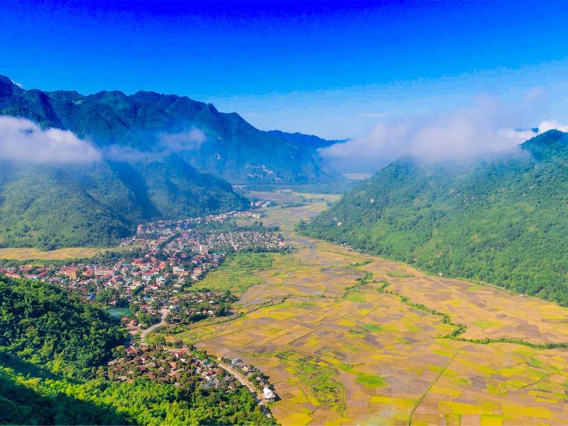 The view at Mai Chau viewpoint on the end of Thung Khe Pass with rice fields, mountains and a small town below