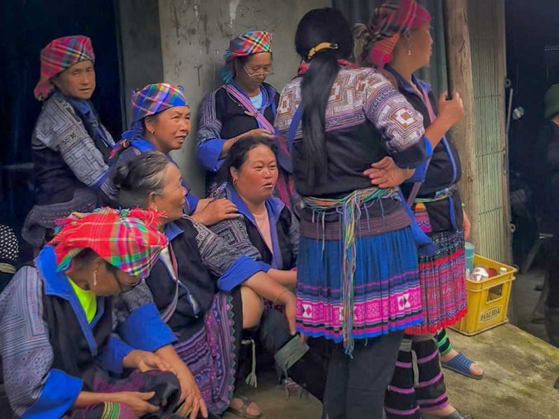 Mu Cang Chai cultural tour with Hmong women gathered in traditional clothing at a local village event