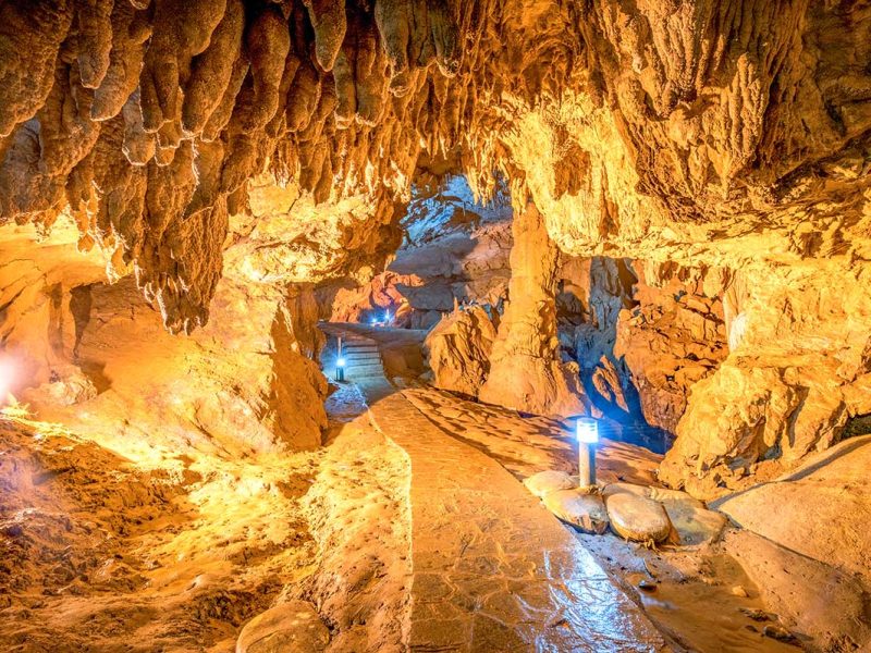 A path with lights going through the Nguom Ngao Cave