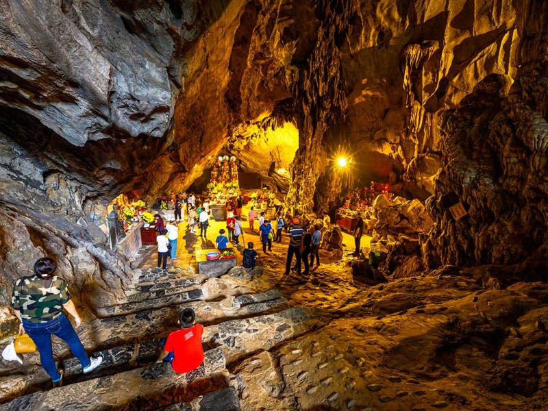 Worshippers praying at the altar inside Huong Tich Cave, the main sanctuary of Perfume Pagoda