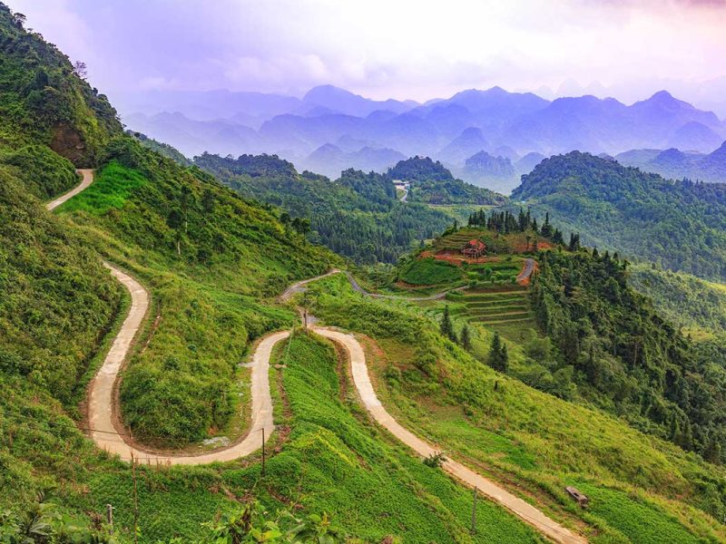 A stunning aerial view of the winding road at Quan Ba Heaven Gate Pass, taken from the highest viewpoint.