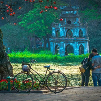 A couple holding each other at Hoan Kiem Lake in Hanoi - Romantic Vietnam