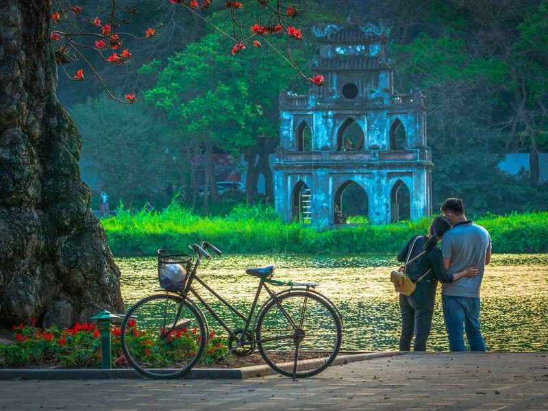 A couple holding each other at Hoan Kiem Lake in Hanoi - Romantic Vietnam