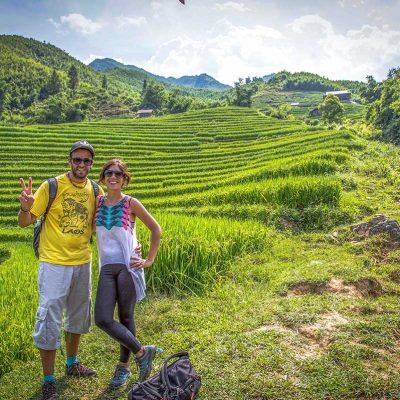 A couple is making a romantic trekking in Sapa through the rice fields while on their honeymoon in Vietnam