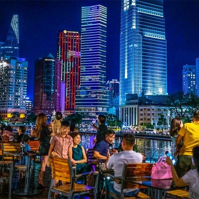 People enjoying the skyline of Ho Chi Minh City from a dinner cruise on the Saigon River