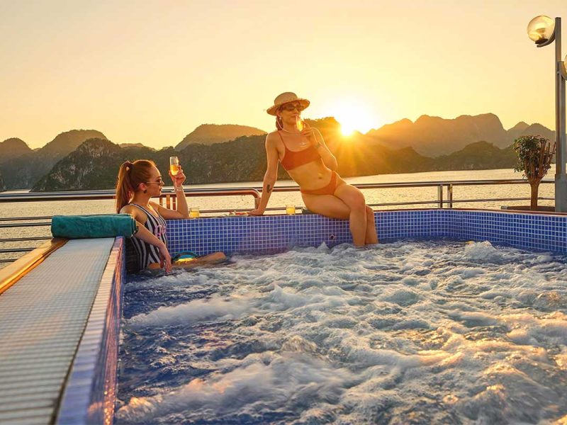 Two girls drinking in jacuzzi at sunset on Sea Lion Cruise