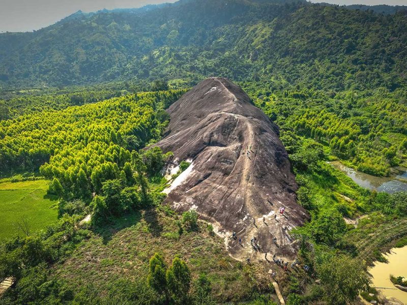A breathtaking aerial view of Yang Tao Elephant Rock, showcasing its massive size and unique shape amidst the surrounding landscape.