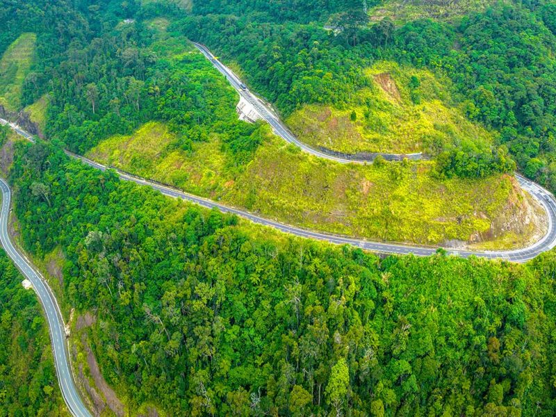 Zigzagging mountain road of Khanh Le Pass seen from above, showcasing one of the most scenic driving routes in Central Vietnam